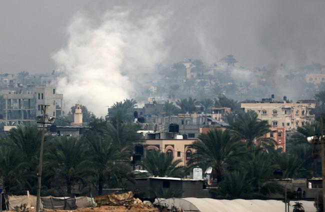 Smoke rises above Khan Yunis in southern Gaza as Israeli troops engage in ground combat in the city