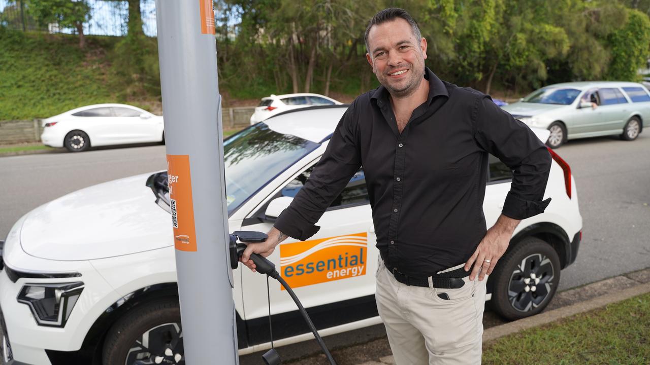 EVX chief executive Andrew Foster uses the trial street-light EV charger in Port Macquarie, New South Wales. It was created as a collaboration between Essential Energy, Toowoomba firm Wagners and EVX.