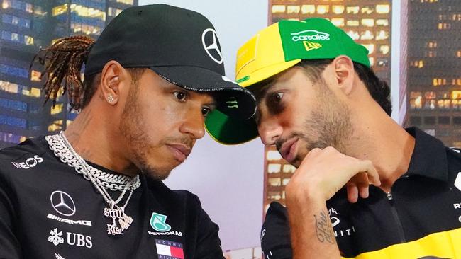 Daniel Ricciardo and Lewis Hamilton deep in discussion during a press conference in Melbourne the day before the GP was cancelled. Picture: AAP