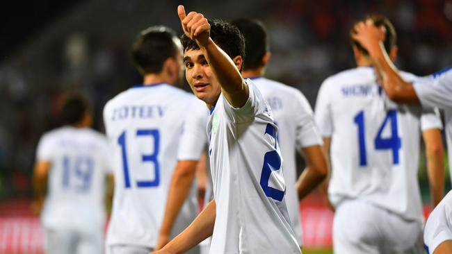 Javokhir Sidikov celebrates his goal against Turkmenistan.