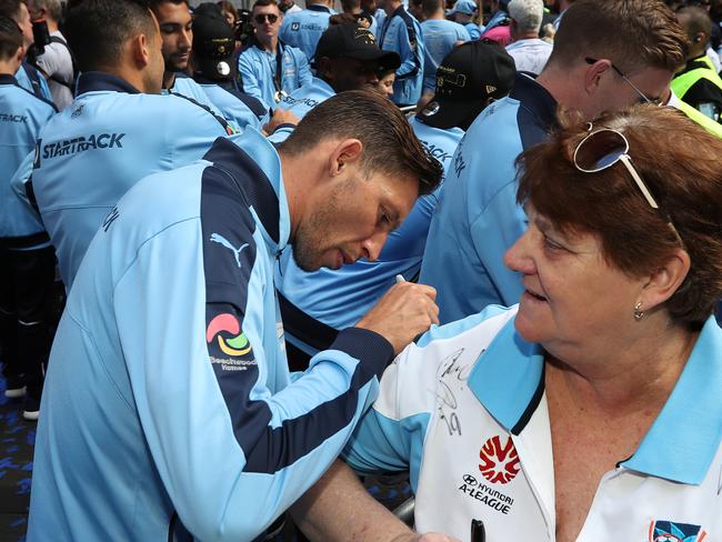 Filip Holosko signs an autograph for a fan after the grand final win.