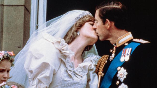 Prince Charles kisses his bride, Lady Diana, on the balcony of Buckingham Palace in 1981. Picture: AFP