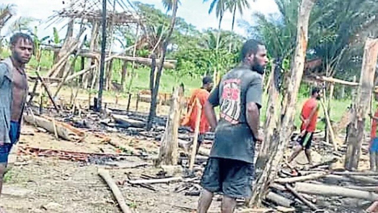 Locals at the scene in Tambari village following the attack. Picture: The National