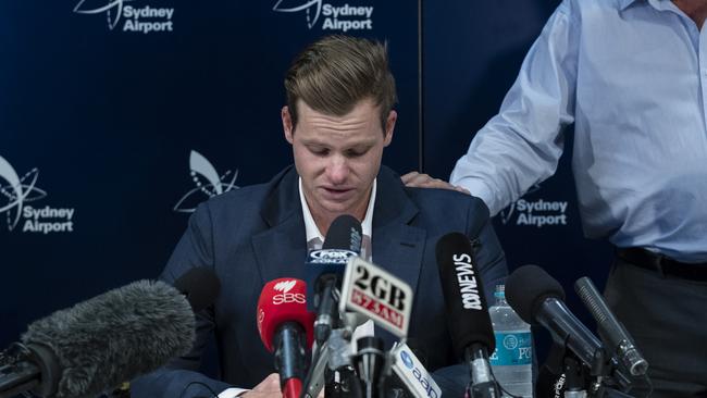 SYDNEY, NEW SOUTH WALES — MARCH 29: An emotional Steve Smith is comforted by his father Peter as he confronts the media at Sydney International Airport on March 29, 2018 in Sydney, Australia. Steve Smith, David Warner and Cameron Bancroft were flown back to Australia following investigations into alleged ball tampering in South Africa. (Photo by Brook Mitchell/Getty Images)