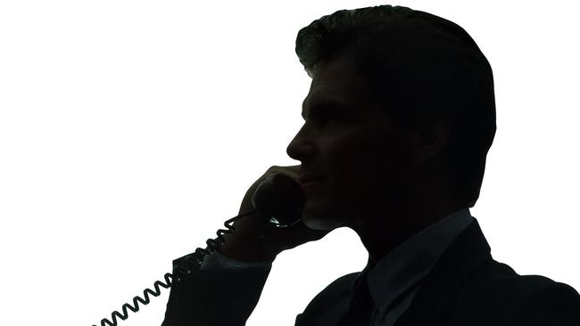 Silhouette of businessman talking on telephone.