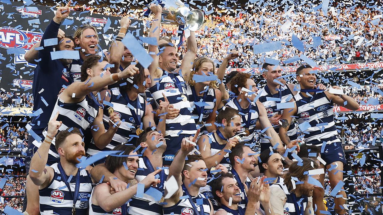 The Cats celebrate with the premiership cup. Picture: Daniel Pockett