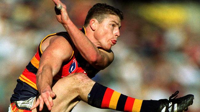 Mark Bickley kicks in 1999. Blight put the boot into him from the top of a ladder. Picture: Michael Dodge