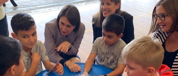 Premier Gladys Berejiklian, Sarah Mitchell and Wendy Lindsay join the children playing cards at Picnic Point Public School.