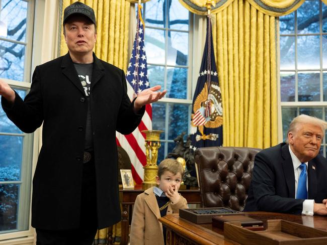 TOPSHOT - Elon Musk speaks as his son X Ã A-Xii and US President Donald Trump look on in the Oval Office of the White House in Washington, DC, on February 11, 2025. Tech billionaire Elon Musk, who has been tapped by President Donald Trump to lead federal cost-cutting efforts, said the United States would go "bankrupt" without budget cuts. Musk leads the efforts under the newly created Department of Government Efficiency (DOGE), and was speaking at the White House with Trump, who has in recent weeks unleashed a flurry of orders aimed at slashing federal spending. (Photo by Jim WATSON / AFP)