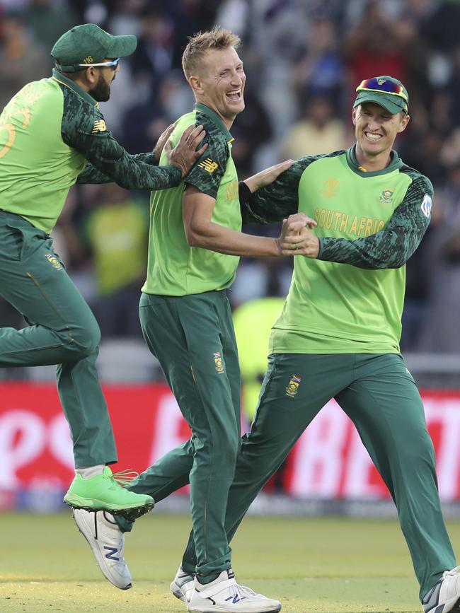 South Africa’s Chris Morris, centre, is congratulated by teammates Tabraiz Shamsi (left) and Dwaine Pretorius after dismissing Alex Carey. Picture: AP