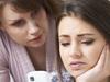 Mother Comforting Daughter Being Bullied By Text Message - Stock Image