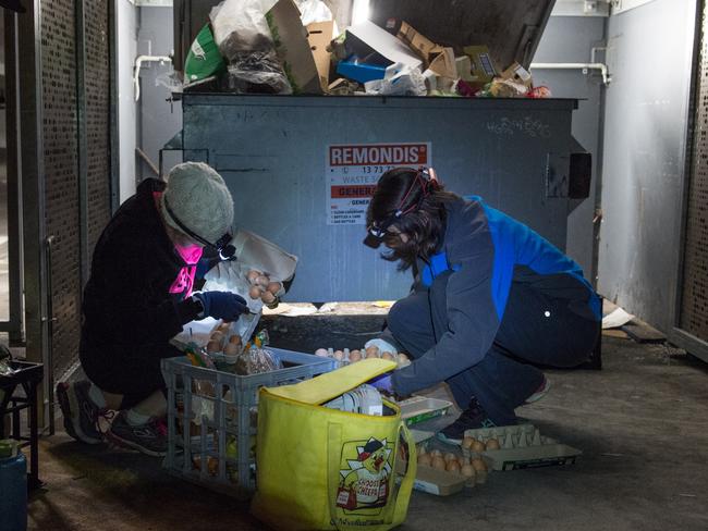 BOUNTY: Miffy and a friend stack a crate and bag with food waste retrieved from a dumpster behind a supermarket. Picture: Brad Fleet