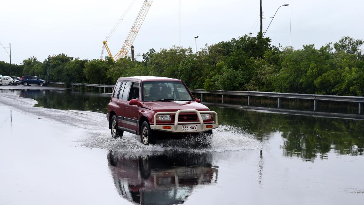 A cra drives through the water over the road at Trawler Base Rd at Portsmith during the high tide PICTURE: ANNA ROGERS