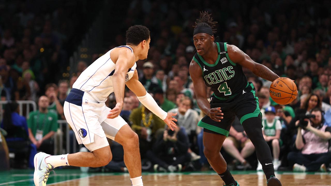 Jrue Holiday dribbles the ball against Josh Green. Maddie Meyer/Getty Images/AFP