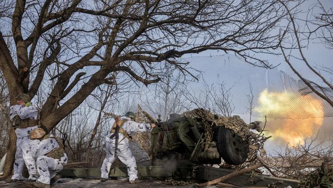 Ukrainian servicemen fire a Howitzer D-30 artillery weapon towards Russian troops. Picture: Reuters