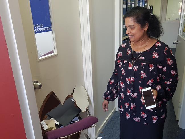 Robert Brown and Co Accounting's Indrani Abeykoon assesses the damage after a car went through her office at Wantirna Mall. Picture: KIEL EGGING.