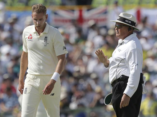 Umpire Marais Erasmus, right, talks to England's Stuart Broad after Broad threw the ball recklessly.