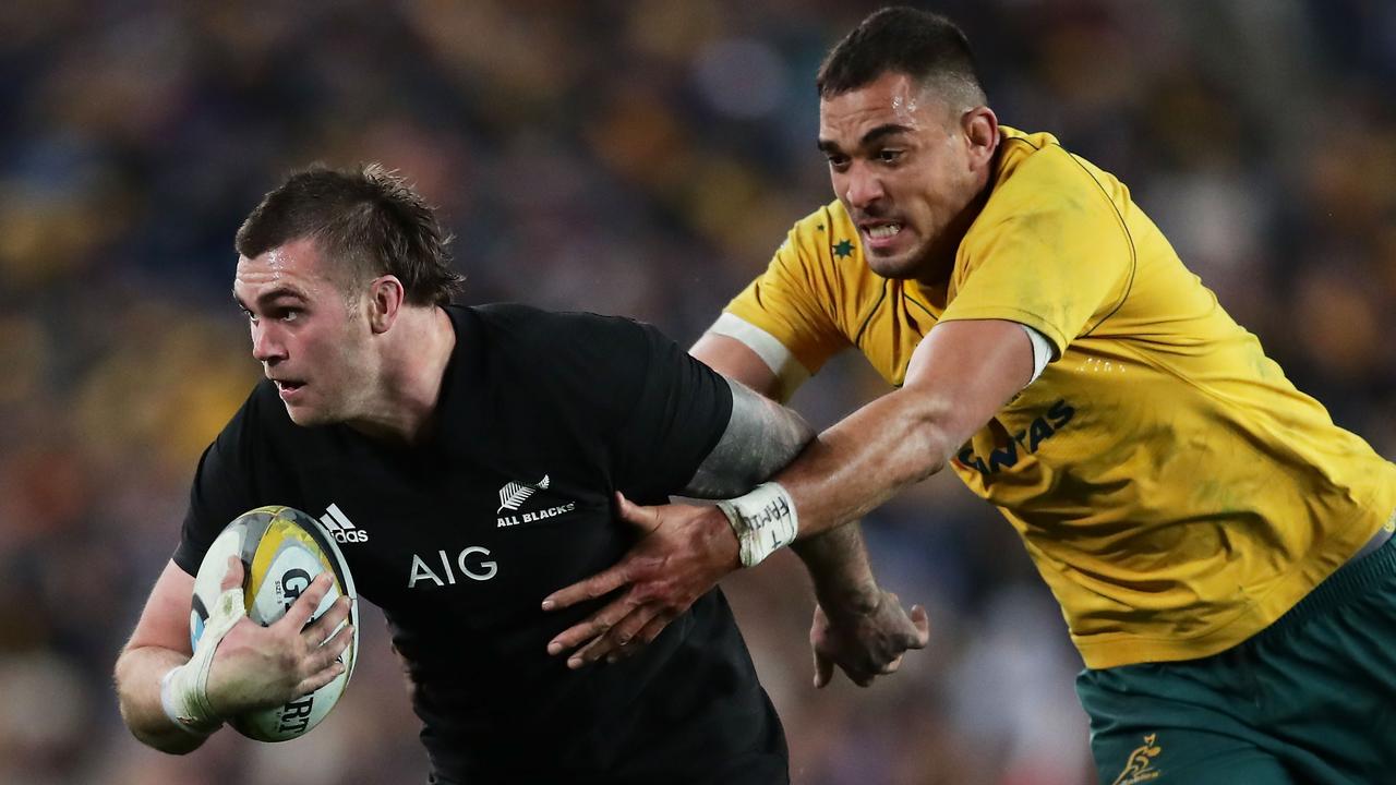 Liam Squire of the All Blacks is tackled by Rory Arnold of the Wallabies.