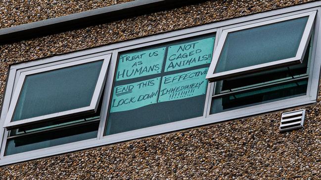 A sign stuck to a window reads: “Treat us as humans, not caged animals, end this lockdown effective immediately”' at the Flemington flats. Picture: Asanka Ratnayake/Getty Images