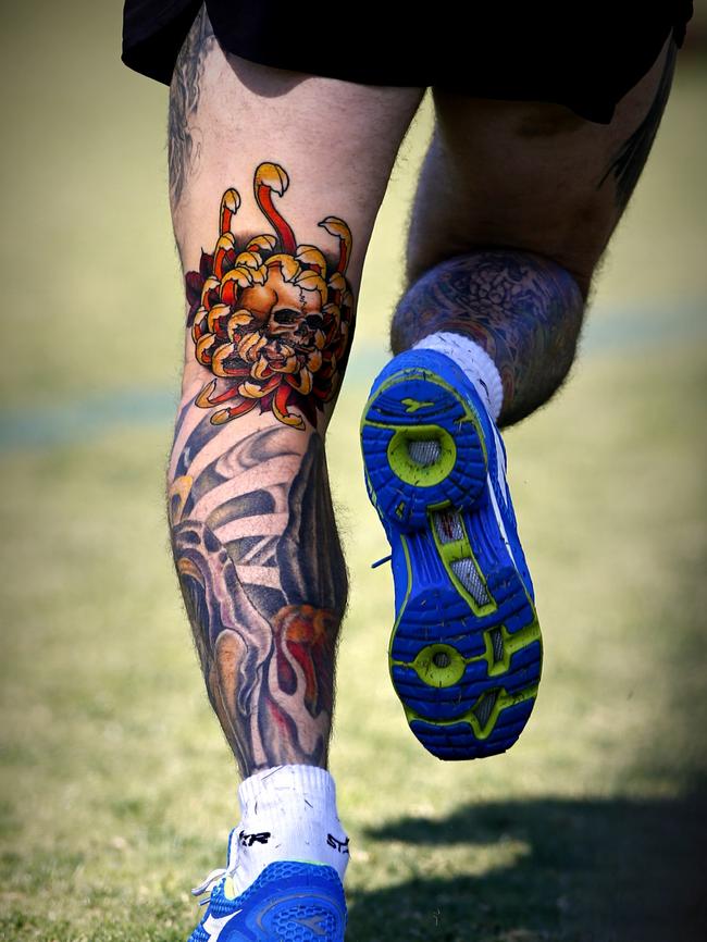 Swan training earlier in the year with his new ink on display. Picture: Wayne Ludbey