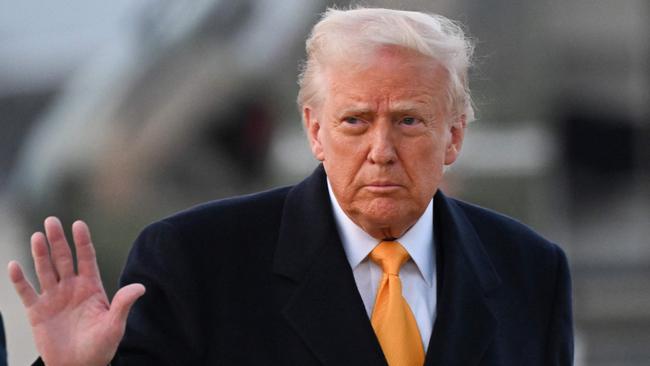 US President Donald Trump waves as he makes his way to board Air Force One at Joint Base Andrews in Maryland on March 7, 2025. Trump is traveling to his Mar-a-Lago resort in Florida. (Photo by ROBERTO SCHMIDT / AFP)