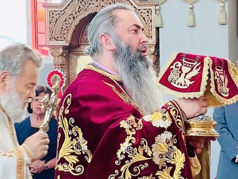 Father John Christodoulos with the communion chalice at St Andrew Parish Picture: Supplied