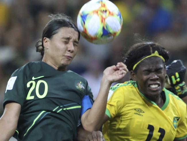 Australia's Sam Kerr, top left, jumps for the ball with Jamaica's Khadija Shaw, center, during the Women's World Cup Group C soccer match between Jamaica and Australia at Stade des Alpes stadium in Grenoble, France, Tuesday, June 18, 2019. (AP Photo/Laurent Cipriani)