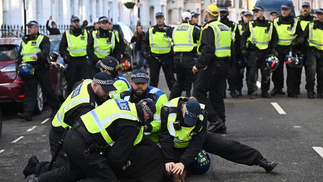 Police officers detain a man in the street close to the 'National March For Palestine' in central London on November 11, 2023. Picture: AFP