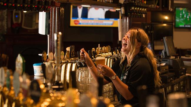 Bartender Leanne Krostiiansen pours the first beer at Shenanigans, Darwin on the day that pubs reopened after the COVID shutdown last year. Picture: Glenn Campbell