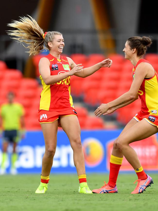 Kalinda Howarth (left) of the Suns celebrates kicking a goal during the Round 3 AFLW match between the Gold Coast Suns and Brisbane Lions at Metricon Stadium on the Gold Coast, Saturday, February 22, 2020 (AAP Image/Darren England)