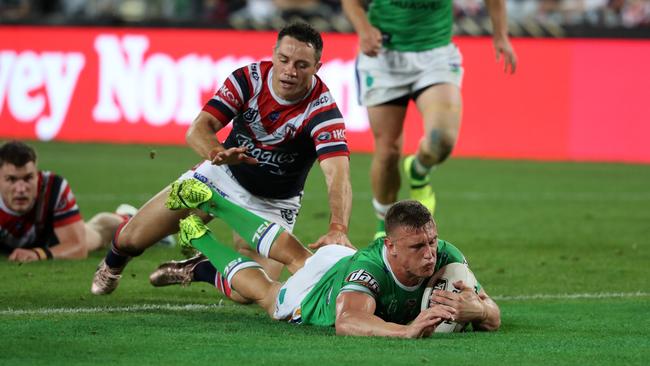 Raiders five-eighth Jack Wighton dives over to score against the Roosters at ANZ Stadium. Picture: Jonathan Ng