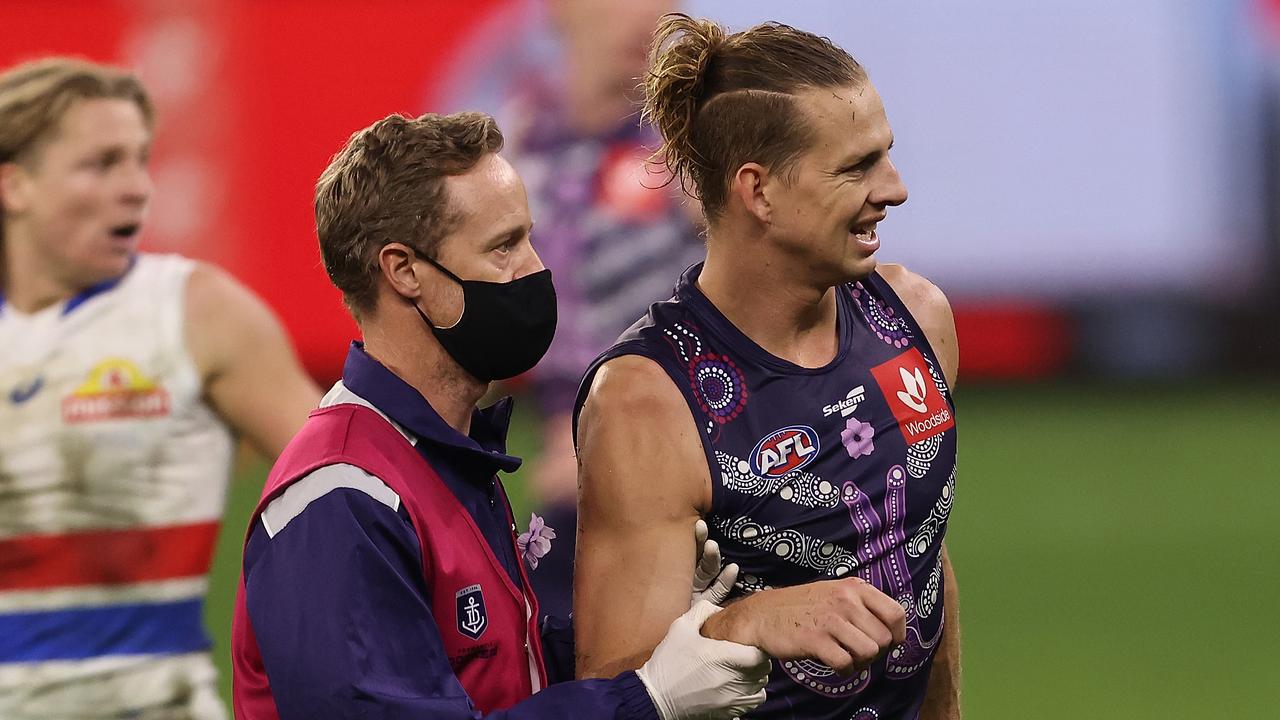 PERTH, AUSTRALIA - JUNE 06: Nat Fyfe of the Dockers is assisted from the field with a shoulder injury during the round 12 AFL match between the Fremantle Dockers and the Western Bulldogs at Optus Stadium on June 06, 2021 in Perth, Australia. (Photo by Paul Kane/Getty Images)