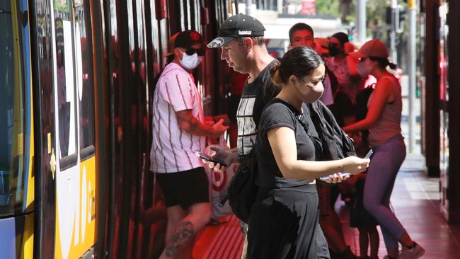 Commuters hop on the light rail at Surfers Paradise. Picture Glenn Hampson