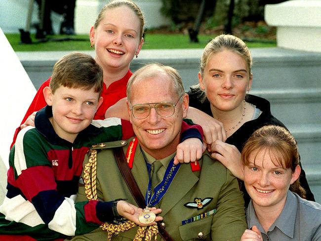 A young Erin (top right), with siblings Sarah, Michael and Felicity when their dad Major General Jim Molan received his AO for distinguished service to the Australian Defence Force.