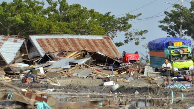 A man stands amid the damage caused by a tsunami in Palu. Picture: AFP