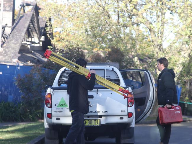 Surveyors at the first Cliff Rd property, where multiple council development applications have been knocked back. Picture: John Grainger