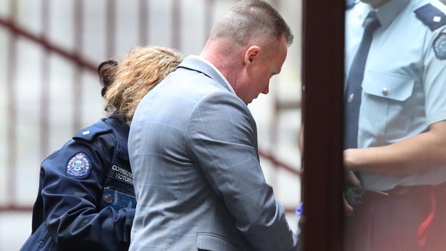 Charles Evans is led into the Supreme Court. Picture: AAP