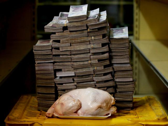 ONE TIME WEB USE ONLY - FEE APPLIES FOR REUSE -  A 2.4 kg chicken is pictured next to 14,600,000 bolivars, its price and the equivalent of 2.22 USD, at a mini-market in Caracas, Venezuela August 16, 2018. It was the going price at an informal market in the low-income neighborhood of Catia. Picture: Carlos Garcia Rawlins/Reuters