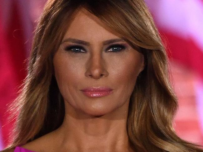 TOPSHOT - US First Lady Melania Trump and US President Donald Trump listen to the US National Anthem, "The Star-Spangled Banner", during the third night of the Republican National Convention at Fort McHenry National Monument in Baltimore, Maryland, August 26, 2020. (Photo by SAUL LOEB / AFP)