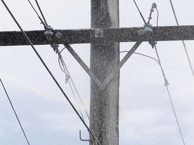 Police,  Queensland Fire and Emergency and Ergon workers attend a fire in a power pole on Mulgrave Rd that caused a black out to over 2000 homes in Cairns . PICTURE: ANNA ROGERS