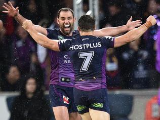 Cameron Smith (left) and Cooper Cronk of the Storm react after winning the NRL preliminary final between the Melbourne Storm and the Canberra Raiders at AAMI Park in Melbourne, Saturday, Sept. 24, 2016. (AAP Image/Julian Smith) NO ARCHIVING, EDITORIAL USE ONLY