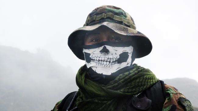 An elite policeman of the DIRANDRO counternarcotics police agency on a mission to arrest drug-toting backpackers. AP Photo/Frank Bajak.