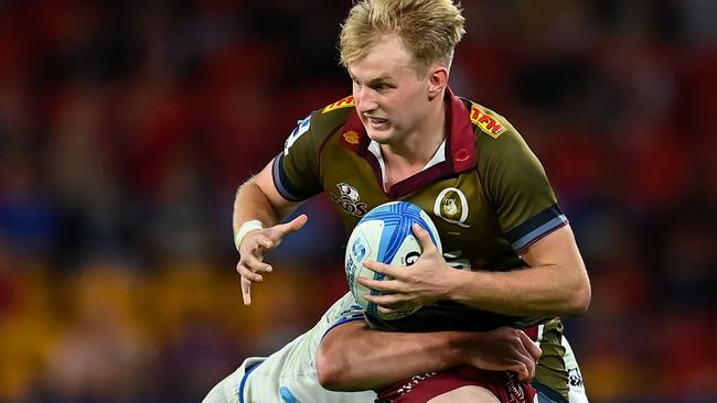 BRISBANE, AUSTRALIA - APRIL 27: Tom Lynagh of the Reds is tackled by Anton Segner of the Blues during the round 10 Super Rugby Pacific match between Queensland Reds and Blues at Suncorp Stadium, on April 27, 2024, in Brisbane, Australia. (Photo by Albert Perez/Getty Images)