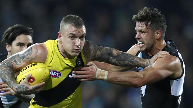 Dustin Martin delivers a trademark fend-off against Port Adelaide in Round 15. Picture Sarah Reed