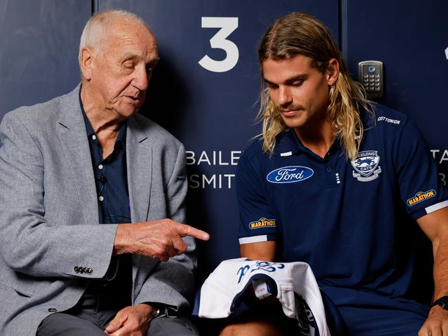 GEELONG, AUSTRALIA - DECEMBER 06: Fred Wooller, the Cats 1963 Premiership Captain poses for a photo with new recruit Bailey Smith and presents him with his number #3 jumper which Bailey will wear in the 2025 season during a Geelong Cats Media Opportunity at GMHBA Stadium on December 06, 2024 in Geelong, Australia. (Photo by Dylan Burns/AFL Photos)