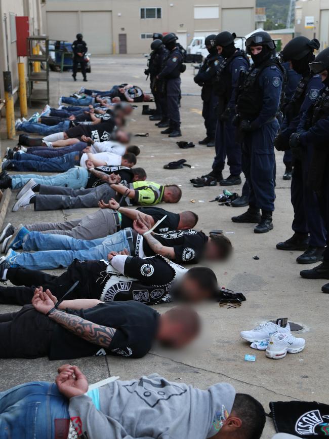 Officers watch over a number of men after a 2015 operation against the Nomads outlaw motorcycle gang. Picture: NSW Police