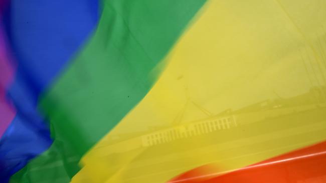 Parliament House is seen through a rainbow flag. Labor No MPs will not exercise a conscience vote. Picture: AAP