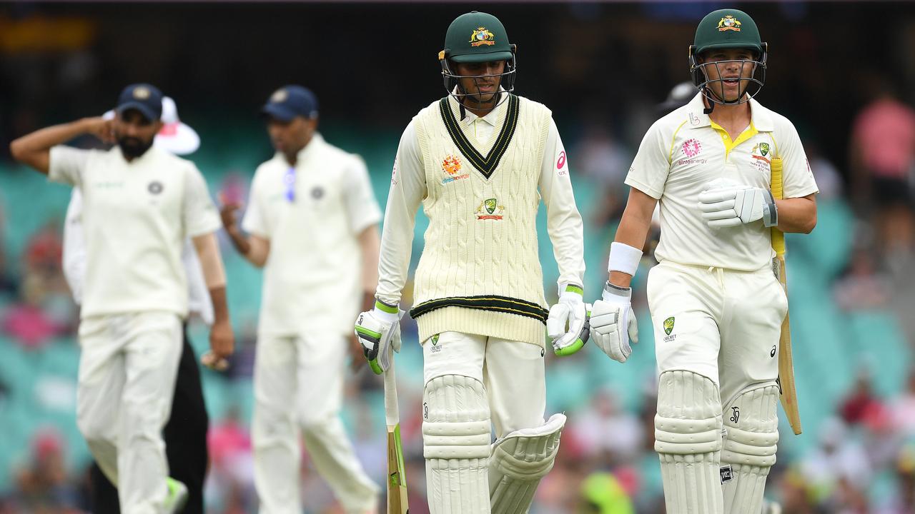 Usman Khawaja and Marcus Harris of Australia leave the field as the tea break is called early due to bad light, on day four of the Fourth Test match between Australia and India at the SCG in Sydney, Sunday, January 6, 2019. (AAP Image/Dan Himbrechts) NO ARCHIVING, EDITORIAL USE ONLY, IMAGES TO BE USED FOR NEWS REPORTING PURPOSES ONLY, NO COMMERCIAL USE WHATSOEVER, NO USE IN BOOKS WITHOUT PRIOR WRITTEN CONSENT FROM AAP