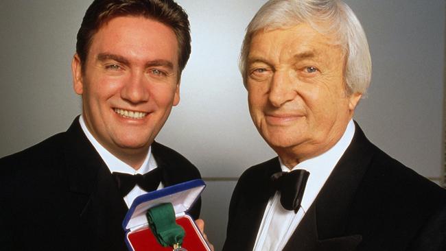 TV presenter Eddie McGuire with cricketer commentator Richie Benaud holding Allan Border Medal for Australia's best cricket performer.