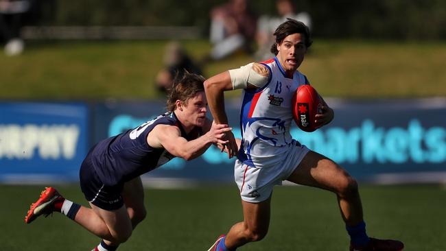 Nathan Philactides shrugs a tackle. Picture: Kelly Defina/AFL Photos/via Getty Images